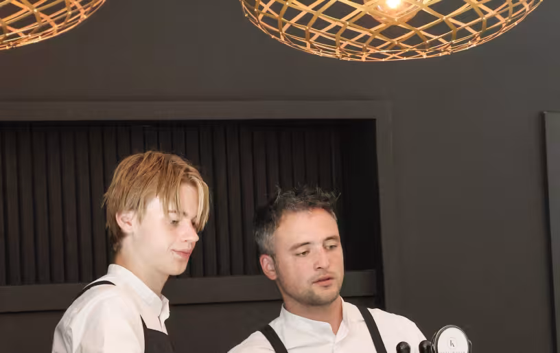 Two men working at a bar